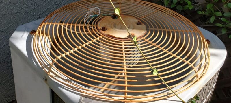 close up of outdoor ac condenser fan + motor view from above unit