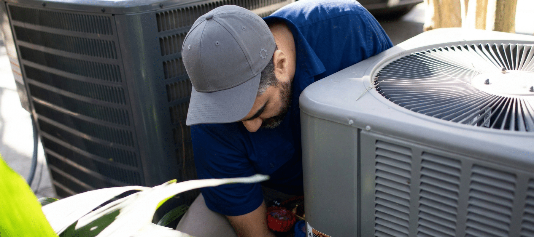 A Robbins Heating & Air Conditioning tech working on a heat pump in Farmington, NM.